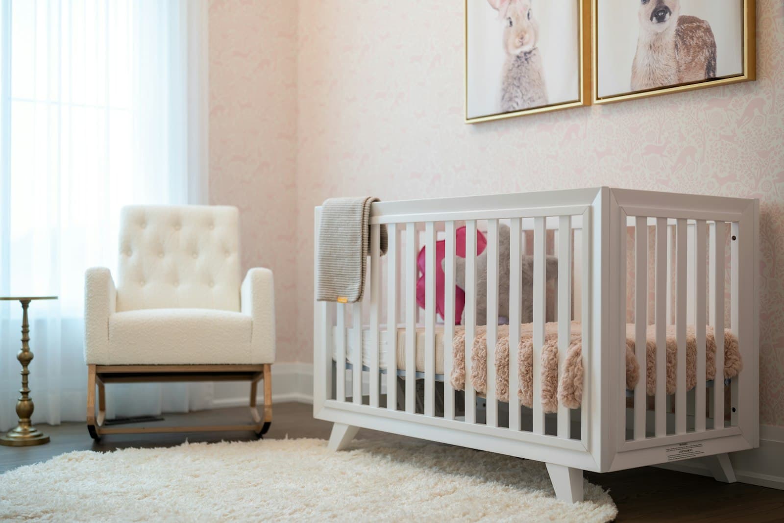 A nursery with a white cot and armchair